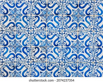 Fragment of building wall with colorful ceramic wall tiles, Azulejo close up. Abstract decorative background, textured ornate pattern for design or backdrop. Traditional ornate Portuguese architecture