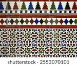 Fragment of building wall with glazed ceramic tiles, embossed vintage Mudejar, close up. Traditional ornate Spanish architecture. Abstract background, textured ornate pattern for design or backdrop.