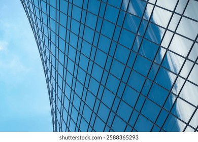 Fragment of a building and windows of a skyscraper. The Evolution Tower in the Moscow-City business center. Fragment of a spiral skyscraper against the sky.