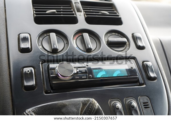 A fragment of a car
panel with buttons and a radio receiver.The interior of a minivan
from the late nineties to the beginning of the two thousandth years
of release.