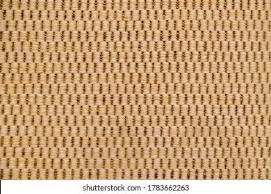 Fragment Of Carpet, Which Is An Alternating Pattern Of Vertical Beige Columns In Four Thick Woolen Threads, Based On Thin Brown Threads Peeking Out On The Background. Textile Abstract Warm Background