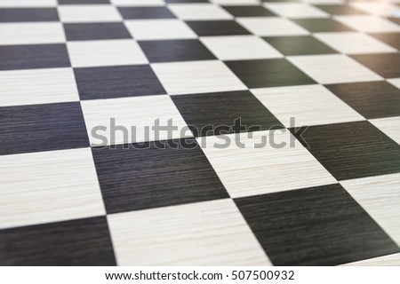 Fragment of a chess board made of wood with a beautiful pattern, background