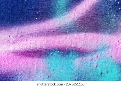 A fragment of colorful graffiti painted on a wall. Abstract urban background for design. - Shutterstock ID 2075651158