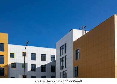 Fragment of a complex of buildings of variable storey with windows of different sizes for articles, blogs, sites on the construction, architectural theme. Copy space