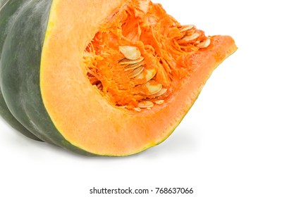 Fragment Of The Cut Winter Squash With Dark Green Rind, Orange Thick Shell And Pulp With Pumpkin Seeds Closeup On A White Background
