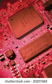 Fragment of the electronic circuit - red computer board with chips and components