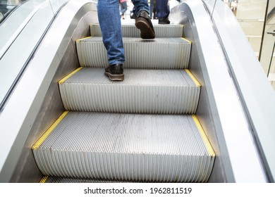 Fragment Of An Escalator With People Going Up. Unrecognizable Person. Back View