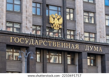 Fragment of the facade of the building of State Duma of the Russian Federation with the emblem of the Russian Federation and the inscription 