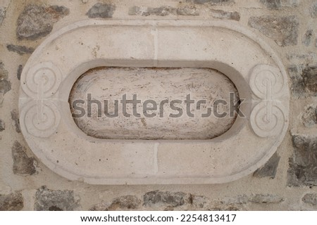 Fragment of the facade of an old house. Elements of the architectural decor of the building. Empty template for text. Architectural stucco detail. Copy space