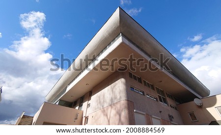 Fragment of the facade of a white modernist building. White building fragment. White facade of the building. Soviet modernism
