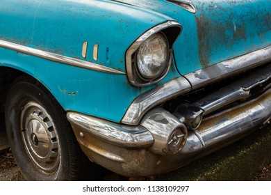 Fragment Of The Front Of The Old Blue Car With A Slightly Rusty Bumper