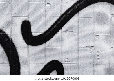 A fragment of a graffiti pattern, applied to a wall of cold tiles, which is covered with a fine condensate. The concept of street art in inappropriate weather
