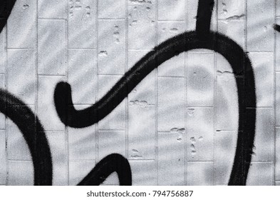 A fragment of a graffiti pattern, applied to a wall of cold tiles, which is covered with a fine condensate. The concept of street art in inappropriate weather