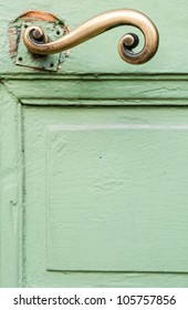 Fragment of green door and golden handle. Nice, France, Europe.
