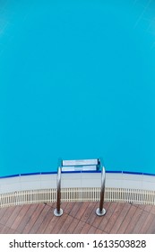 Fragment Of Inground Swimming Pool With Metal Ladder