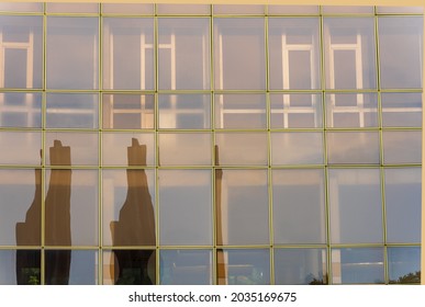 A Fragment Of Large Office Windows With A Reflection Of The Urban Environment In Them