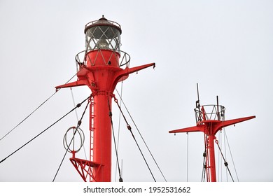 Fragment Of Mast And Signal Lamp Of Floating Beacon, Close Up. Sailing Mast Of Ship On Cloudy Sky Background. Vessel Main Mast.