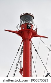 Fragment Of Mast And Signal Lamp Of Floating Beacon, Close Up. Sailing Mast Of Ship On Cloudy Sky Background. Vessel Main Mast.