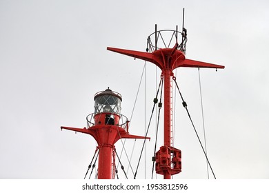 Fragment Of Mast And Signal Lamp Of Floating Beacon, Close Up. Sailing Mast Of Ship On Cloudy Sky Background. Vessel Main Mast.