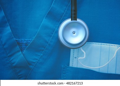 Fragment of medical work wear with protective mask and stethoscope.