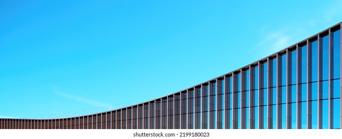 Fragment of the mirror wall of the building against the blue sky.
office building covered with glass. Place for an inscription, advertising. Panorama. - Powered by Shutterstock