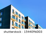 Fragment of Modern residential apartment with flat buildings exterior. Detail of New luxury house and home complex. Part of City Real estate property and condo architecture. Copy space. Blue sky