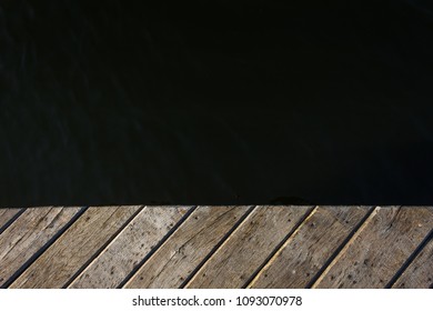 Fragment of an old wooden pier on the background of water. Copy space. Background  - Shutterstock ID 1093070978