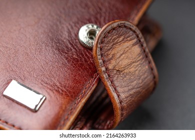 Fragment Of An Old Worn Wallet Made Of Genuine Leather. Macro Photography.