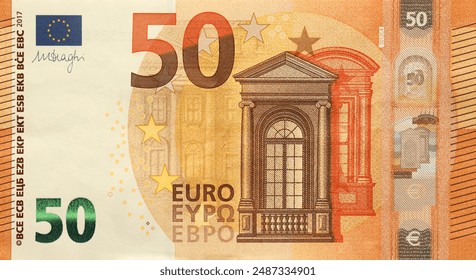 Fragment of one fifty euro money bill. Details of European union currency banknote of 50 euro close up - Powered by Shutterstock