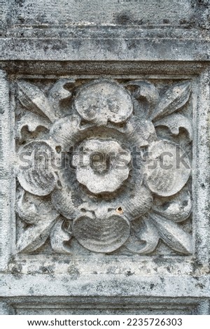 Fragment of an ornament on a stone, decoration for a stone wall or fence.