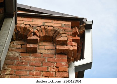 a fragment of the parapet of an old historic building with a downpipe