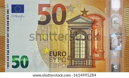 Fragment part of 50 euro banknote close-up with small brown details
