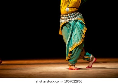 Fragment photo of indian dancer, only legs cropped, Legs fragment photo of indian odissi dancer. Women from folk music group presenting traditional indian costume. Dancer in movement photo