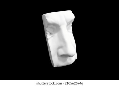 Fragment of plaster sculpture of a human face isolated on black background. High quality photo