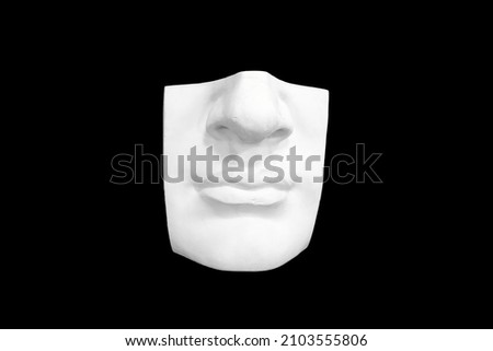 Fragment of plaster sculpture of a human face isolated on black background. High quality photo