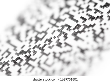 Fragment Quick Response Code on paper close up. Abstract background with blur.