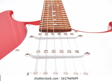Fragment of a red electric guitar on a white background. Part of the guitar. Music object. - Powered by Shutterstock