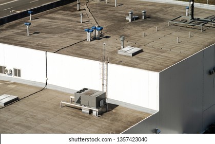 Fragment of the roof of a commercial building with a external units of the commercial air conditioning and ventilation systems.