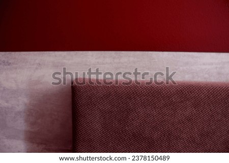 fragment of the soft back of the bed near the red wall