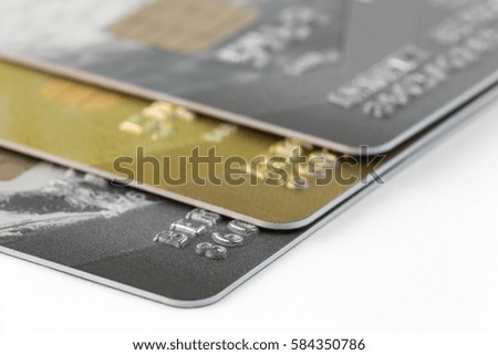 fragment of a stack of three credit cards with a focus on near card