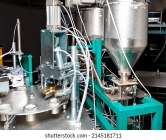 Fragment of a stainless steel distribution mechanism of a production line in the food industry for batch distribution of food liquid products. - Shutterstock ID 2145181711