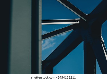 A fragment of the steel structure of the railroad bridge against the sky.  - Powered by Shutterstock