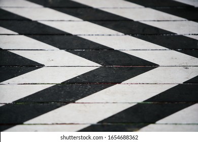 Fragment of a striped wrinkled black and white piece of a cloth fabric as a background texture