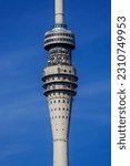 Fragment of a television tower with a television center against the blue sky near the center of Dresden in Germany.