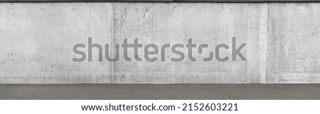 a fragment of an urban concrete wall of a building and an asphalt sidewalk, a building facade, a template or source