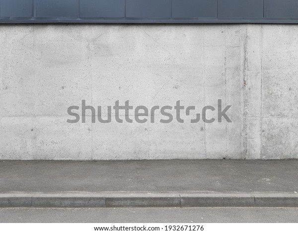a\
fragment of an urban concrete wall of a building and an asphalt\
sidewalk, a building facade, a template or\
source
