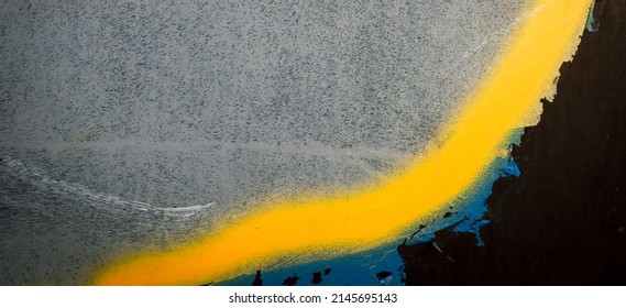 Fragment of the wall with blue yellow colors graffiti painting. Part of colorful street art graffiti on wall background