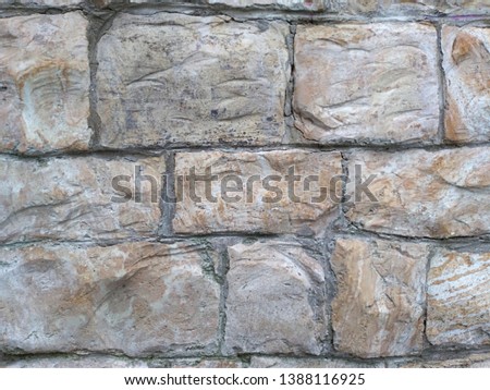 Fragment of the wall.  Large rectangular stones.  Fragment of stonework.  Roughly treated stones. The texture of stone bricks.  Stacked stone blocks. Natural stone bricks. 
