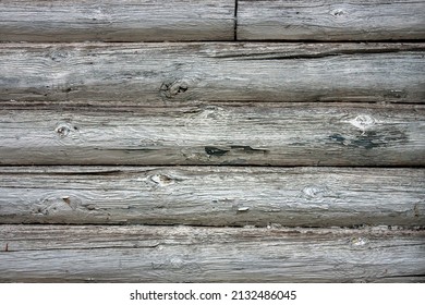 Fragment of a wall made of old logs. Close-up, flat lay. Natural tree. Texture of natural wood close up. Natural wood cladding.