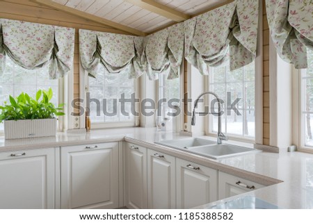 Fragment of white kitchen with many windows